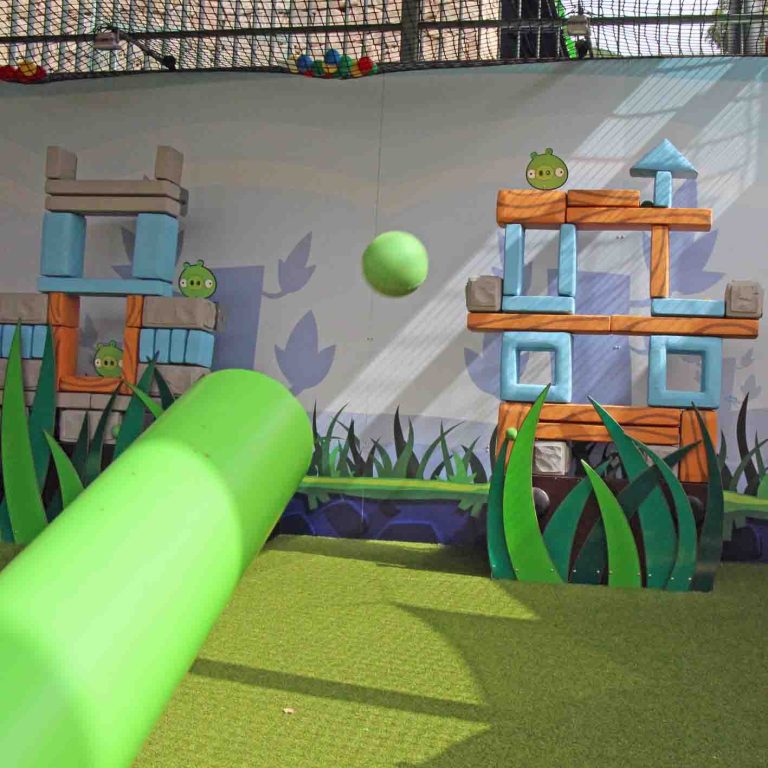 Play area with Angry Birds theme, featuring a green ramp and colorful structures.