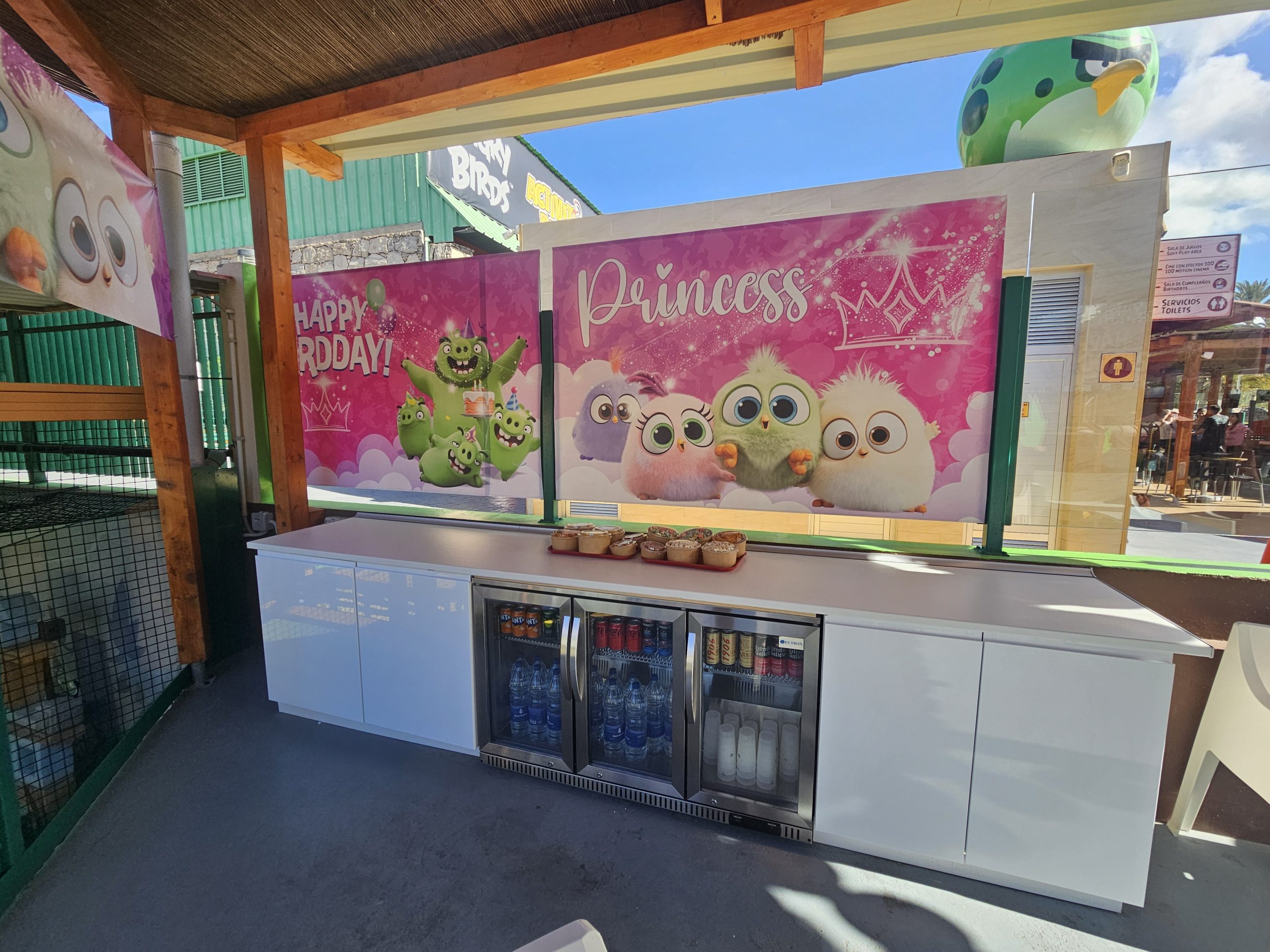 Party setup with Angry Birds decorations and refreshments on a counter.