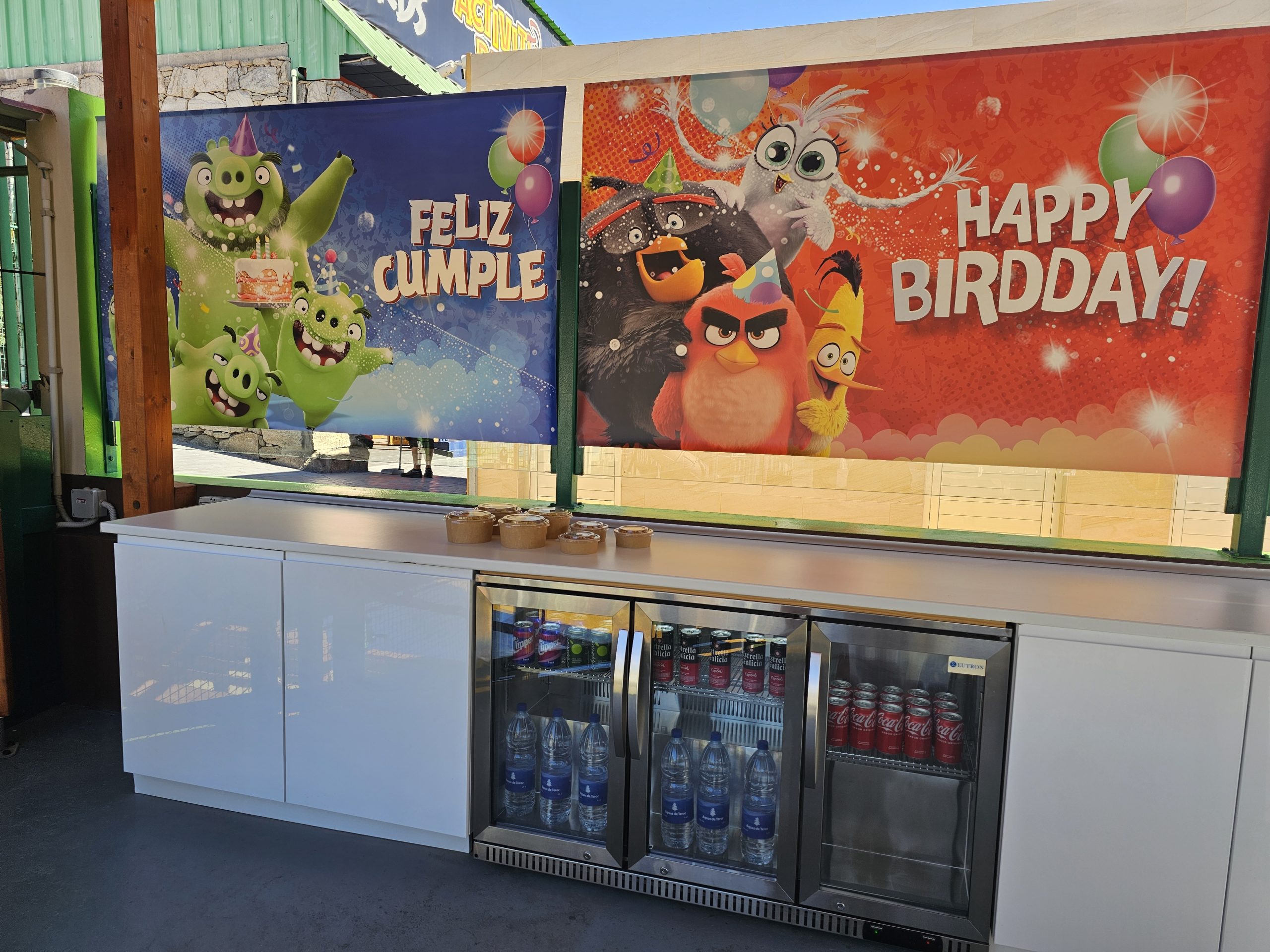 Beverage cooler with festive Angry Birds birthday banners above.