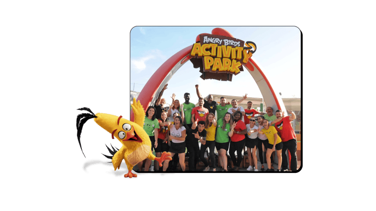Group of people in front of Angry Birds Activity Park entrance with a cartoon bird.