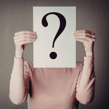 Person holding a paper with a large question mark over their face.