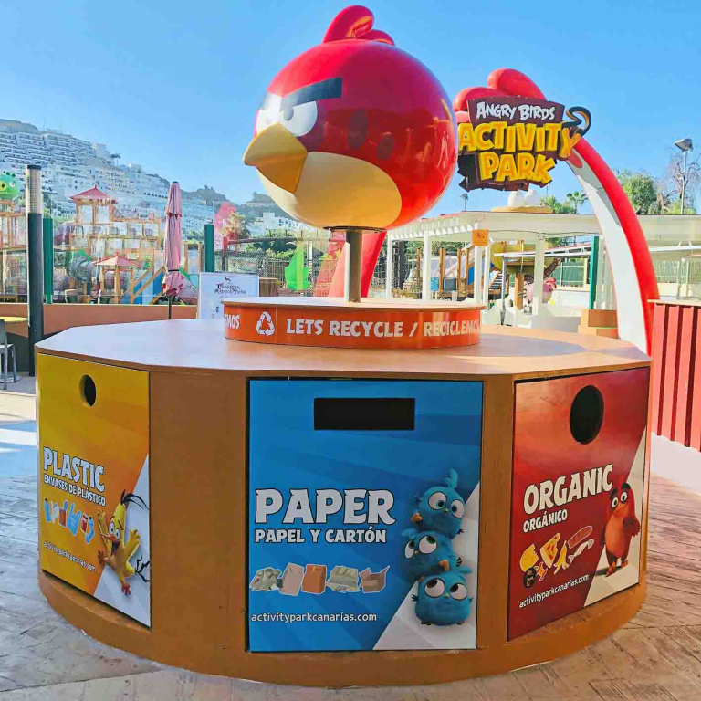 Recycling bins with Angry Birds theme at a park entrance.